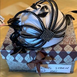 White straw hat with black feathers and rhinestone